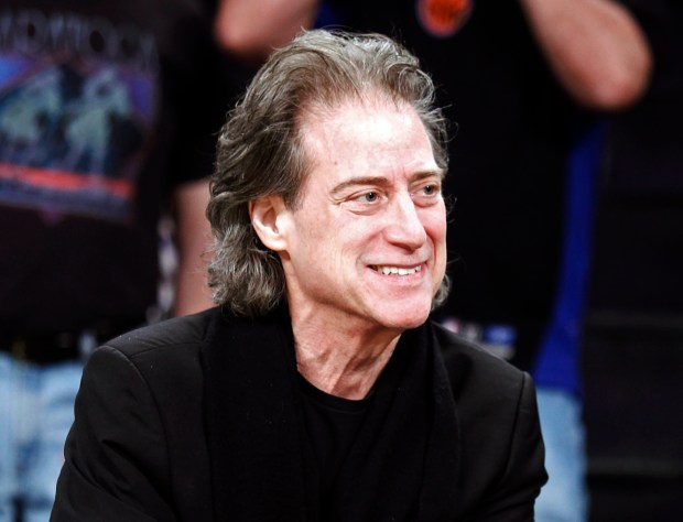 FILE - Comedian Richard Lewis attends an NBA basketball game in Los Angeles on Dec. 25, 2012. Lewis, an acclaimed comedian known for exploring his neuroses in frantic, stream-of-consciousness diatribes while dressed in all-black, leading to his nickname "The Prince of Pain," has died. He was 76. He died at his home in Los Angeles on Tuesday night after suffering a heart attack, according to his publicist Jeff Abraham. (AP Photo/Alex Gallardo, File)