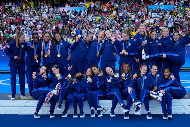 The United States soccer team players pose with their gold medals after the women's soccer gold medal match between Brazil and the United States at the Parc des Princes during the 2024 Summer Olympics, Saturday, Aug. 10, 2024, in Paris, France. (AP Photo/Francisco Seco)