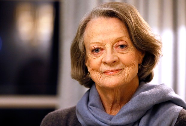 FILE - British actress Dame Maggie Smith poses in London on Dec. 16, 2015. Smith, who won an Oscar for "The Prime of Miss Jean Brodie" in 1969 and won new fans in the 21st century as the dowager Countess of Grantham in "Downton Abbey," has died at 89. (AP Photo/Kirsty Wigglesworth, File)