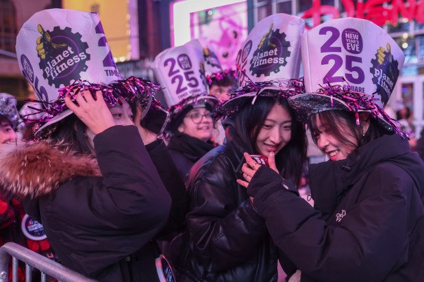 Revelers take photos as they wait for midnight during the annual New Year's Eve celebration in Times Square, Tuesday, Dec. 31, 2024, in New York. (AP Photo/Heather Khalifa)