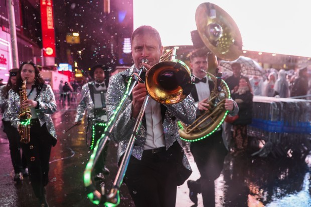 A performance takes place in the rain during the annual New Year's Eve celebration in Times Square, Tuesday, Dec. 31, 2024, in New York. (AP Photo/Heather Khalifa)