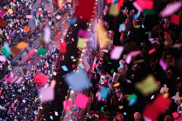 Revelers watch and record as confetti falls over Times Square during the annual New Year's Eve celebration, Wednesday, Jan. 1, 2025, in New York. (AP Photo/Heather Khalifa)