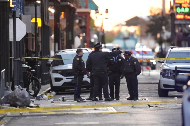 Security personnel gather at the scene on Bourbon Street after a vehicle drove into a crowd on New Orleans' Canal and Bourbon Street, Wednesday Jan. 1, 2025. (AP Photo/Gerald Herbert)