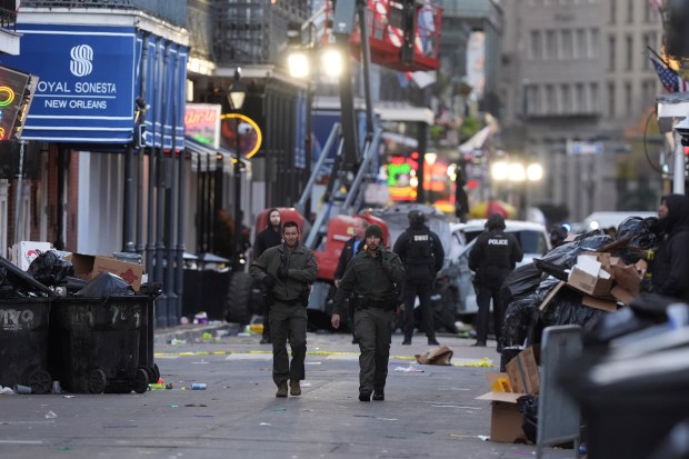 Emergency services attend the scene after a vehicle drove into a crowd on New Orleans' Canal and Bourbon Street, Wednesday Jan. 1, 2025. (AP Photo/Gerald Herbert)