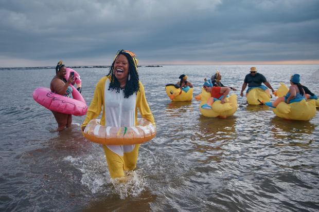 Revelers in costumes enter the cold water during the annual Polar Bear Plunge on New Year's Day, Wednesday, Jan. 1, 2025, in New York. (AP Photo/Andres Kudacki)