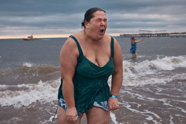 A reveler walks away after entering the cold water during the annual Polar Bear Plunge on New Year's Day, Wednesday, Jan. 1, 2025, in New York. (AP Photo/Andres Kudacki)