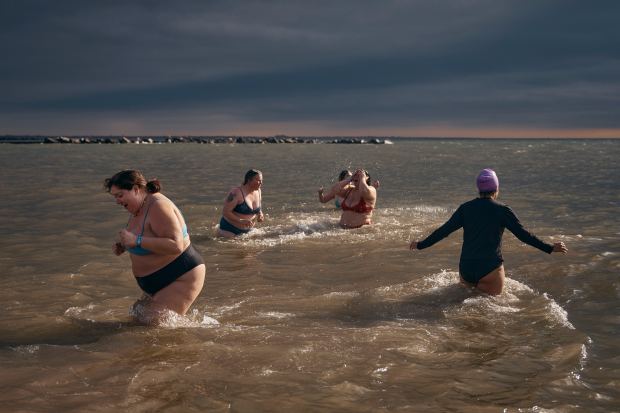 Revelers enter the cold water during the annual Polar Bear Plunge on New Year's Day, Wednesday, Jan. 1, 2025, in New York. (AP Photo/Andres Kudacki)