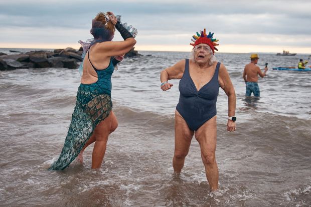 Revelers in a costumes wade in cold water during the annual Polar Bear Plunge on New Year's Day, Wednesday, Jan. 1, 2025, in New York. (AP Photo/Andres Kudacki)