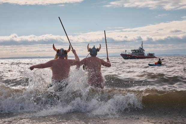 Revelers in a costume enter the cold water during the annual Polar Bear Plunge on New Year's Day, Wednesday, Jan. 1, 2025, in New York. (AP Photo/Andres Kudacki)