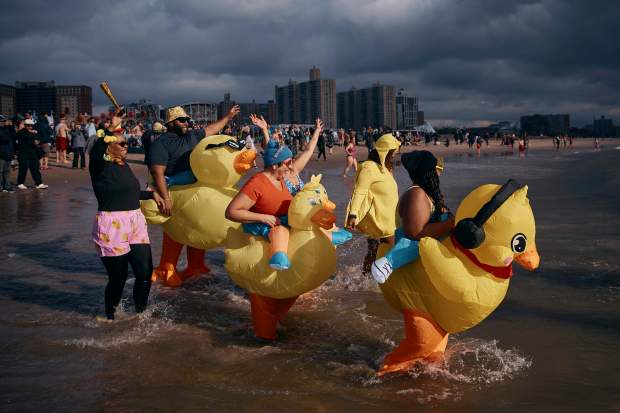 Revelers in a costume enter the cold water during the annual Polar Bear Plunge on New Year's Day, Wednesday, Jan. 1, 2025, in New York. (AP Photo/Andres Kudacki)