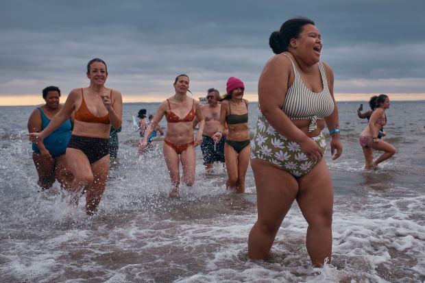 Revelers walk away after entering the cold water during the annual Polar Bear Plunge on New Year's Day, Wednesday, Jan. 1, 2025, in New York. (AP Photo/Andres Kudacki)