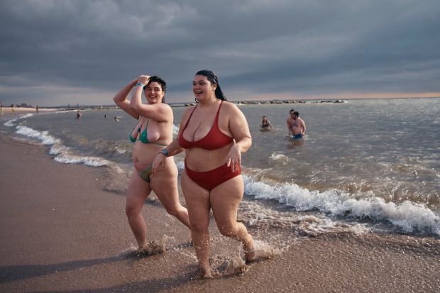 Revelers wearing bikinis walk away after entering the cold water during the annual Polar Bear Plunge on New Year's Day, Wednesday, Jan. 1, 2025, in New York. (AP Photo/Andres Kudacki)