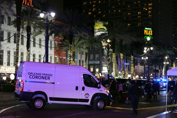 A coroner's van leaves the scene after a vehicle drove into a crowd on New Orleans' Canal and Bourbon streets, Wednesday, Jan. 1, 2025. (AP Photo/George Walker IV)