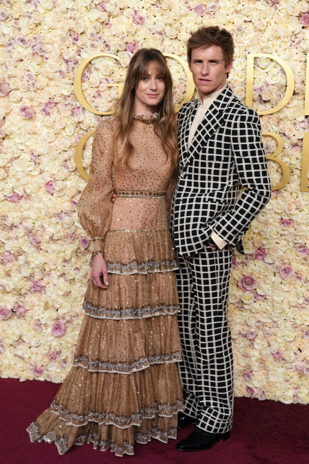 Hannah Bagshawe, left, and Eddie Redmayne arrive at the 82nd Golden Globes on Sunday, Jan. 5, 2025, at the Beverly Hilton in Beverly Hills, Calif. 