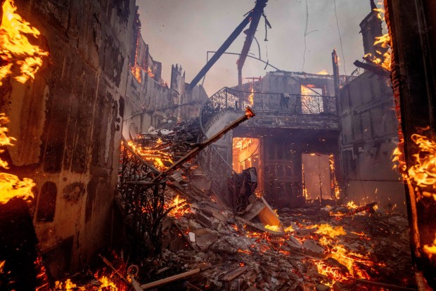 The Palisades Fire burns a residence in the Pacific Palisades neighborhood 