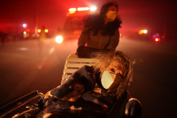 A resident of a senior center is evacuated as the Eaton Fire approaches