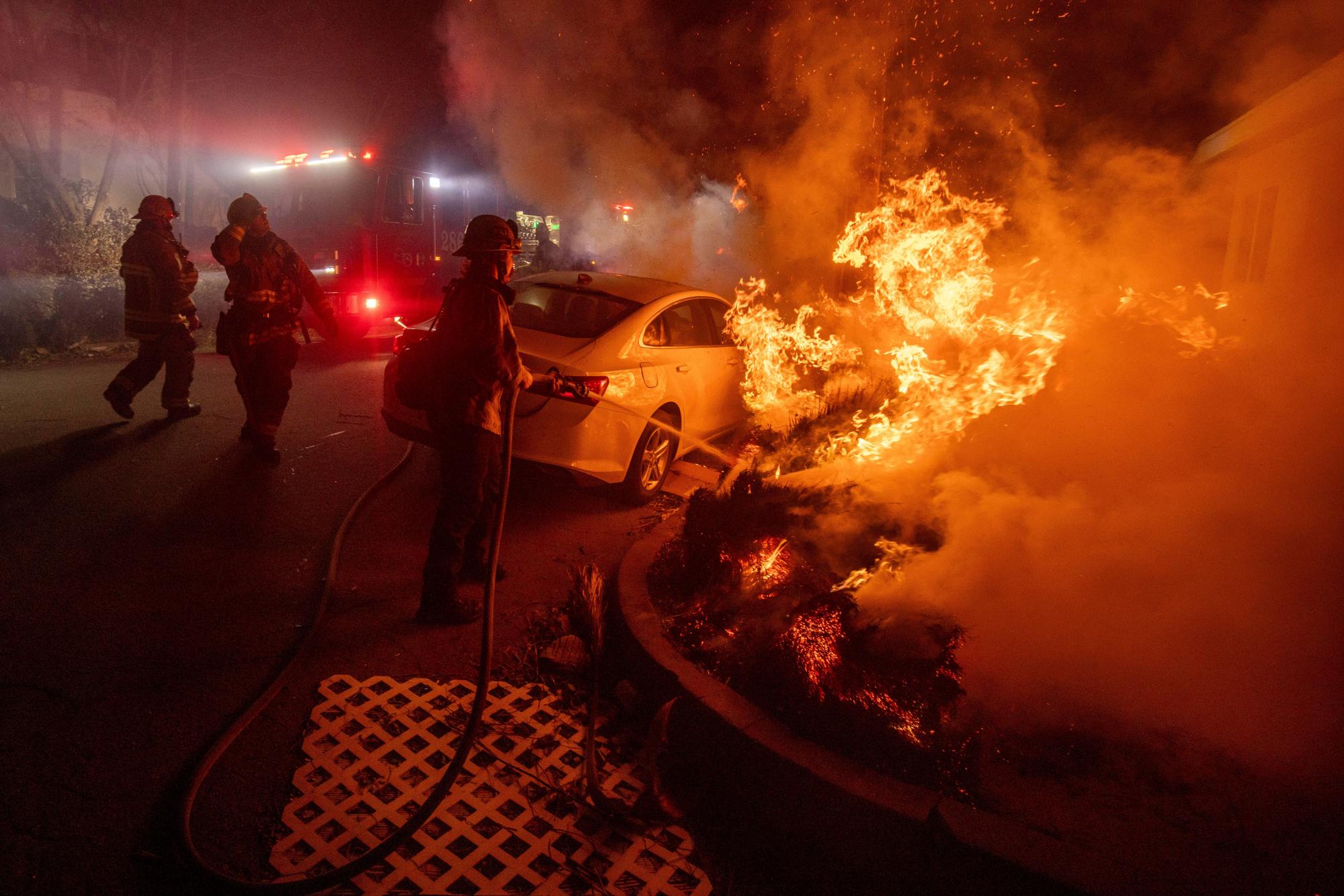 Firefighters battle the Eaton Fire Tuesday, Jan. 7, 2025 in Altadena, Calif. (AP Photo/Ethan Swope)