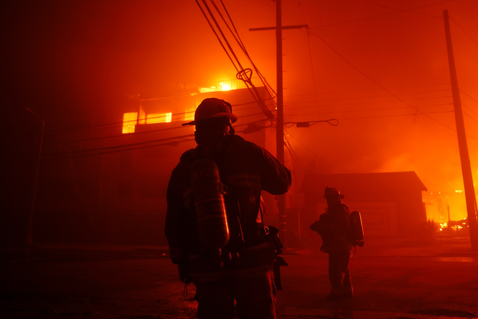 Firefighters battle the Palisades Fire in the Pacific Palisades neighborhood of Los Angeles, Tuesday, Jan. 7, 2025. (AP Photo/Etienne Laurent)