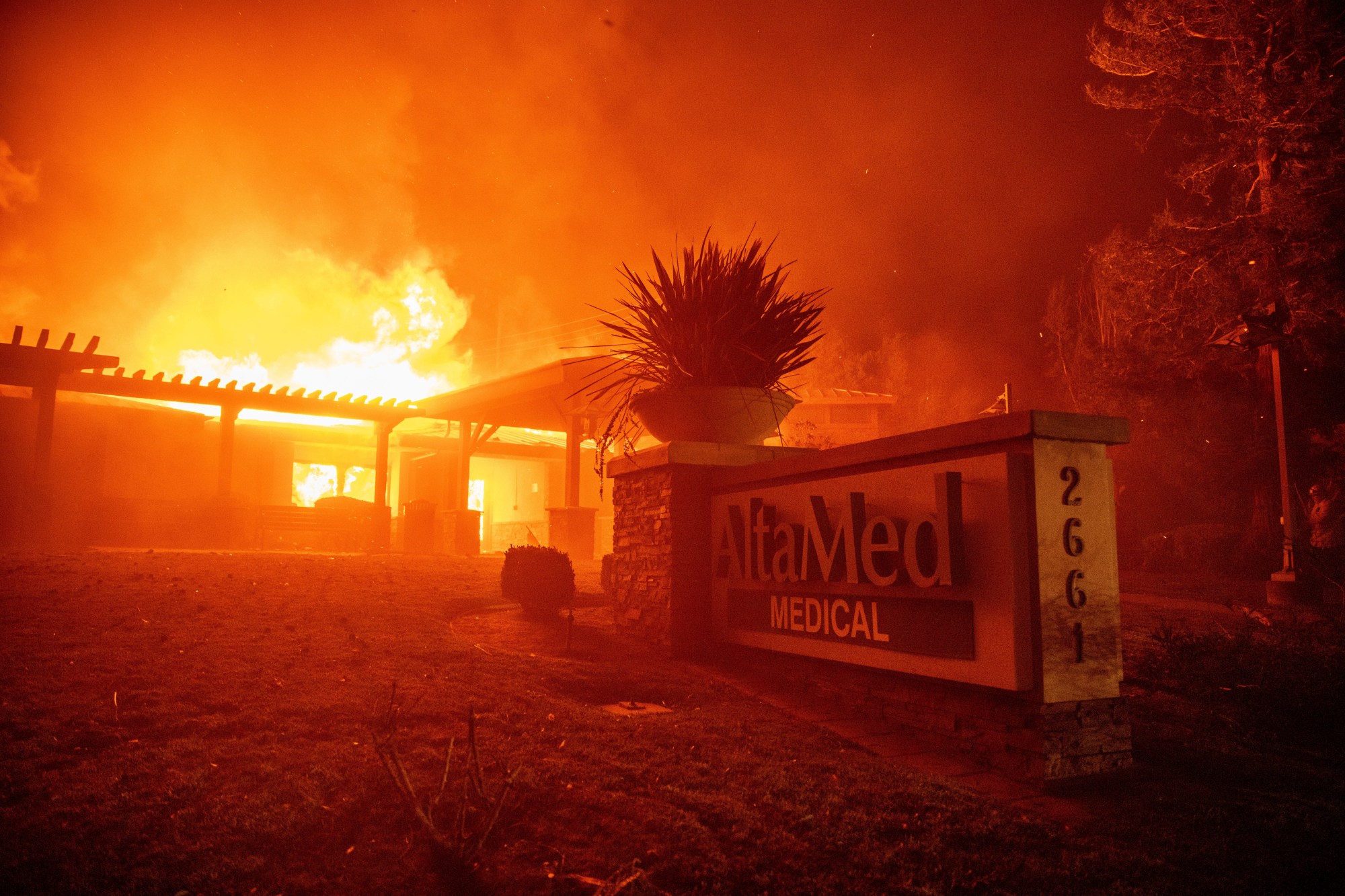 The Eaton Fire burns the AltaMed Medical building Wednesday, Jan. 8, 2025 in Altadena, Calif. (AP Photo/Ethan Swope)