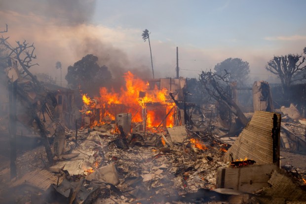 The Palisades Fire burns a structure in the Pacific Palisades neighborhood of Los Angeles, Wednesday, Jan. 8, 2025. (AP Photo/Etienne Laurent)