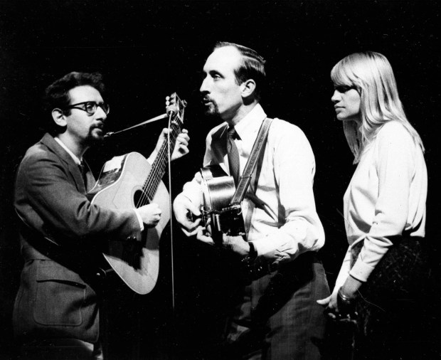 American folk trio Peter, Paul and Mary are shown during rehearsals at the London Palladium, Nov. 8, 1965, for the Royal Variety Performance in front of Queen Elizabeth II and Prince Philip. From left to right: Paul Stookey, Peter Yarrow, and Mary Travers (AP Photo/Bob Dear)