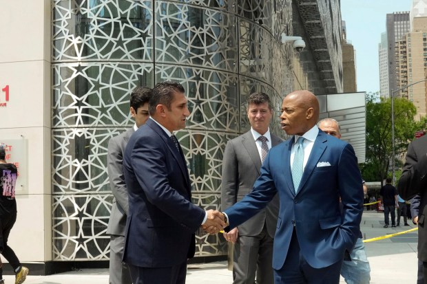 This photo, released by Office of the New York Mayor, shows New York Mayor Eric Adams, right, visiting the Turkish Consulate General building, background, after it was vandalized, in New York, May 22, 2023. Others are unidentified. (Michael Appleton/Mayoral Photography Office via AP)