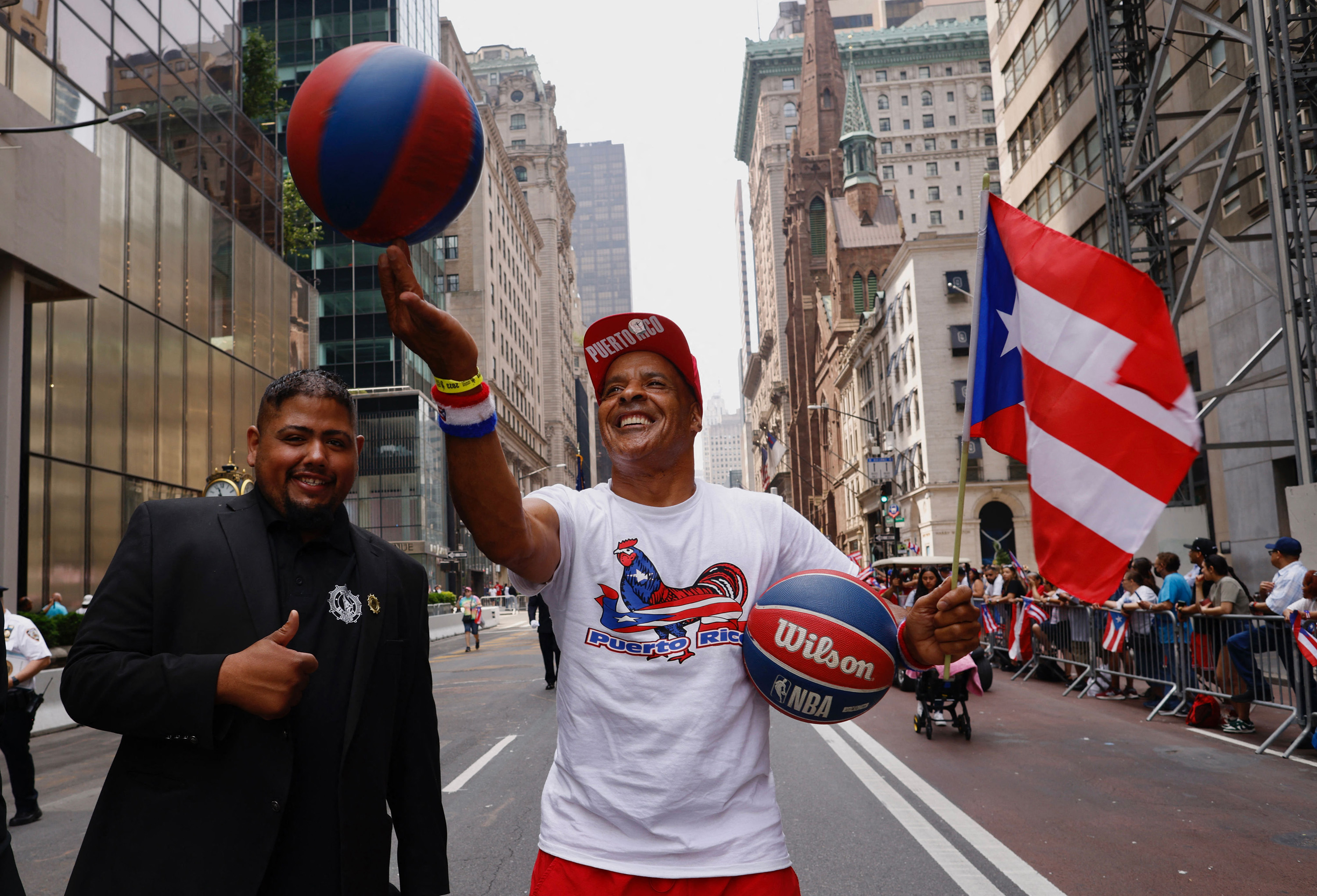 Ricardo Boronia spins a basketball on his finger while marching in the 66th annual National Puerto Rican Day Parade in New York City on June 11, 2023.