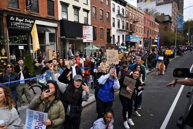 Spectators cheer runners during the 52nd Edition of the New York City Marathon on November 5, 2023. (Photo by ANGELA WEISS / AFP) (Photo by ANGELA WEISS/AFP via Getty Images)