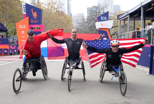 Men's Pro Wheelchair Division winner Marcel Hug (C) of Switzerland, second-placed Daniel Romanchuk of the US and third-placed Jetze Plat of the Netherlands pose for a picture during the awards ceremony at the 2023 New York City Marathon in New York on November 5, 2023. (Photo by TIMOTHY A. CLARY / AFP) (Photo by TIMOTHY A. CLARY/AFP via Getty Images)