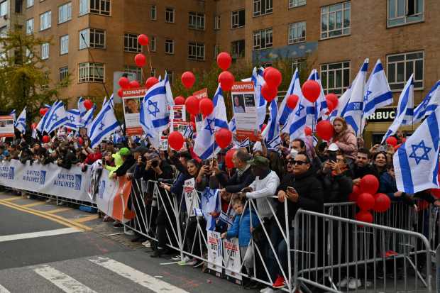 People wave Israeli flags as they watch the 52nd Edition of the New York City Marathon on November 5, 2023. (Photo by ANGELA WEISS / AFP) (Photo by ANGELA WEISS/AFP via Getty Images)