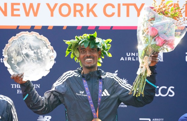 Ethiopia's Tamirat Tola poses on the podium after winning the 52nd Edition of the New York City Marathon on November 5, 2023. (Photo by TIMOTHY A. CLARY / AFP) (Photo by TIMOTHY A. CLARY/AFP via Getty Images)