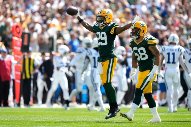 GREEN BAY, WISCONSIN - SEPTEMBER 15: Xavier McKinney #29 of the Green Bay Packers celebrates with teammate Isaiah McDuffie #58 after intercepting a pass against the Indianapolis Colts during the first quarter at Lambeau Field on September 15, 2024 in Green Bay, Wisconsin. (Photo by Patrick McDermott/Getty Images)