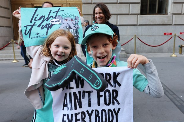 NEW YORK, NEW YORK - OCTOBER 24: New York Liberty fans Haley De Leon and Ezra Hollar-Steinfeld wait for the start of their WNBA championship parade on Broadway on October 24, 2024 in New York City. Fans lined the streets north along Broadway to City Hall through what's known as the "Canyon of Heroes" to celebrate the Liberty's first WNBA championship after a 67-62 overtime victory on Sunday over the Minnesota Lynx. The Liberty were the top seed with a league-best 32-8 record. (Photo by Michael M. Santiago/Getty Images)