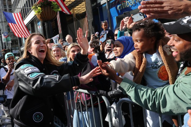 NEW YORK, NEW YORK - OCTOBER 24: New York Liberty Guard Sabrina Ionescu greets fans as she celebrates the team winning the WNBA championship during their parade on October 24, 2024 in New York City. Fans lined the streets north along Broadway to City Hall through what's known as the "Canyon of Heroes" to celebrate the Liberty's first WNBA championship after a 67-62 overtime victory on Sunday over the Minnesota Lynx. The Liberty were the top seed with a league-best 32-8 record. (Photo by Michael M. Santiago/Getty Images)