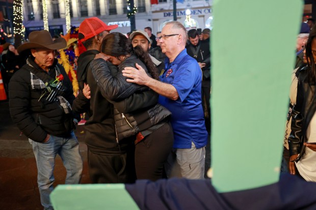 NEW ORLEANS, LOUISIANA - JANUARY 4: The family of LaTasha Polk, the final Bourbon Street terror attack victim to be identified, console one another next to fourteen crosses set up on Canal Street near Bourbon Street on January 4, 2025 in New Orleans, Louisiana. Fourteen people were killed and over 30 were injured when a driver intentionally drove into a crowd on Bourbon Street in the early morning hours of New Year's Day in what police are calling a terrorist attack. (Photo by Michael DeMocker/Getty Images)