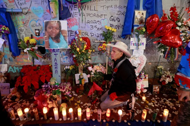 NEW ORLEANS, LOUISIANA - JANUARY 4: Artist Roberto Marquez places flowers next to a photo of LaTasha Polk, who was the final Bourbon Street terror attack victim to be identified, at a memorial on Bourbon Street at Canal Street on January 4, 2025 in New Orleans, Louisiana. Fourteen people were killed and over 30 were injured when a driver intentionally drove into a crowd on Bourbon Street in the early morning hours of New Year's Day in what police are calling a terrorist attack. (Photo by Michael DeMocker/Getty Images)