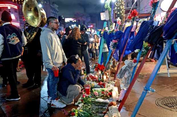 NEW ORLEANS, LOUISIANA - JANUARY 4: A man and woman grieve in front of a cross dedicated to Bourbon Street terror attack victim Nicole Perez at a memorial on Canal Street near Bourbon Street on January 4, 2025 in New Orleans, Louisiana. Fourteen people were killed and over 30 were injured when a driver intentionally drove into a crowd on Bourbon Street in the early morning hours of New Year's Day in what police are calling a terrorist attack. (Photo by Michael DeMocker/Getty Images)