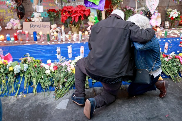 NEW ORLEANS, LOUISIANA - JANUARY 4: Louis and Cathy Tenedorio, parents of Bourbon Street terror attack victim Matthew Tenedorio, embrace in front of a memorial on Bourbon Street at Canal Street on January 4, 2025 in New Orleans, Louisiana. Fourteen people were killed and over 30 were injured when a driver intentionally drove into a crowd on Bourbon Street in the early morning hours of New Year's Day in what police are calling a terrorist attack. (Photo by Michael DeMocker/Getty Images)