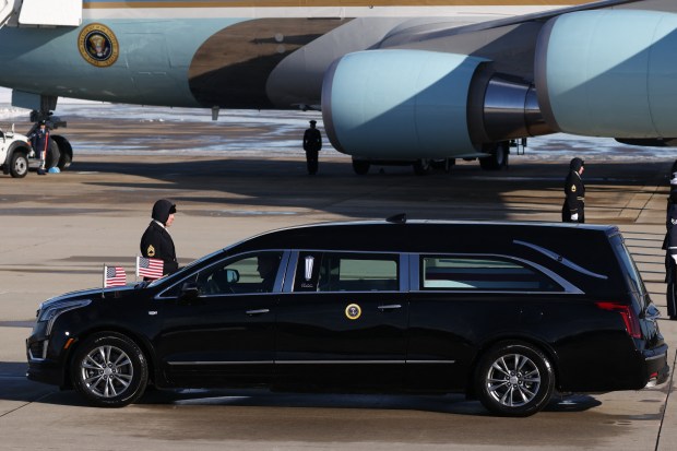 The flag-draped casket of former US President Jimmy Carter is tranfered to a hearse during an arrival ceremony in Joint Base Andrews, Maryland, on January 7, 2025. Carter, the 39th President of the United States, died at the age of 100 on December 29, 2024 at his home in Plains, Georgia. (Photo by Samuel Corum / AFP) (Photo by SAMUEL CORUM/AFP via Getty Images)