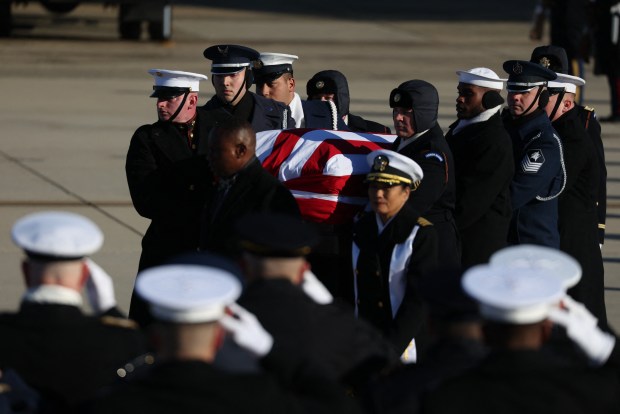 Members of a military honor cordon transfer the flag-draped casket of former US President Jimmy Carter to a hearse during an arrival ceremony in Joint Base Andrews, Maryland, on January 7, 2025. Carter, the 39th President of the United States, died at the age of 100 on December 29, 2024 at his home in Plains, Georgia. (Photo by Samuel Corum / AFP) (Photo by SAMUEL CORUM/AFP via Getty Images)