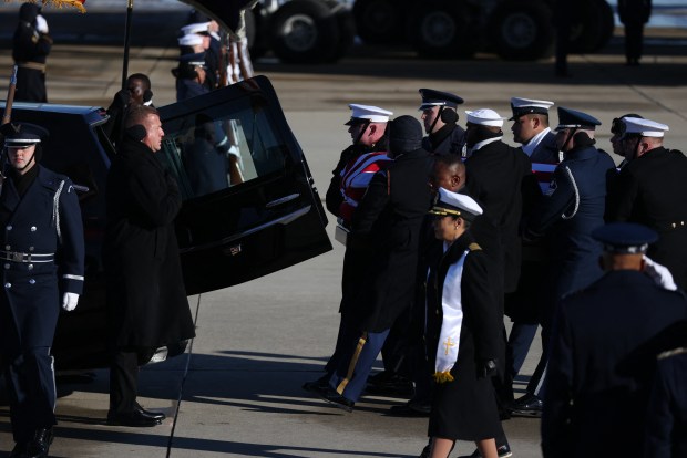 Members of a military honor cordon transfer the flag-draped casket of former US President Jimmy Carter to a hearse during an arrival ceremony in Joint Base Andrews, Maryland, on January 7, 2025. Carter, the 39th President of the United States, died at the age of 100 on December 29, 2024 at his home in Plains, Georgia. (Photo by Samuel Corum / AFP) (Photo by SAMUEL CORUM/AFP via Getty Images)