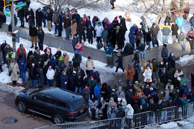 Spectators wait for the casket of former US President Jimmy Carter to arrive at the U.S. Navy Memorial before traveling on to the Capitol building in Washington, DC on January 7, 2025. Carter, the 39th President of the United States, died at the age of 100 on December 29, 2024 at his home in Plains, Georgia. (Photo by Mark Schiefelbein / POOL / AFP) (Photo by MARK SCHIEFELBEIN/POOL/AFP via Getty Images)