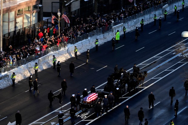 WASHINGTON, DC - JANUARY 7: The flag-draped casket of former President Jimmy Carter travels in a horse-drawn caisson from the U.S. Navy Memorial to the Capitol to lie in state on January 7, 2025 in Washington, DC. Carter's body will lie in state in the Capitol Rotunda until a funeral service at the National Cathedral in Washington on January 9. Carter, the 39th President of the United States, died at the age of 100 on December 29, 2024 at his home in Plains, Georgia. (Photo by Mark Schiefelbein-Pool/Getty Images)