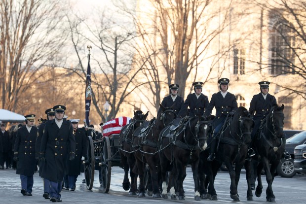 WASHINGTON, DC - JANUARY 7: The flag-draped casket of former President Jimmy Carter is transported on a horse-drawn caisson to the U.S. Capitol on January 7, 2025 in Washington, DC. Carter's body will lie in state in the Capitol Rotunda until a funeral service at the National Cathedral in Washington on January 9. Carter, the 39th President of the United States, died at the age of 100 on December 29, 2024 at his home in Plains, Georgia. (Photo by Evelyn Hockstein-Pool/Getty Images)