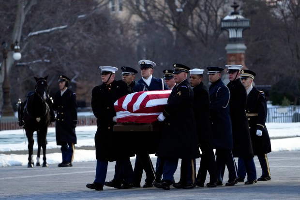 WASHINGTON, DC - JANUARY 7: The flag-draped casket of former President Jimmy Carter is carried by a joint services body bearer team on the East Front of U.S. Capitol on January 7, 2025 in Washington, DC. Carter's body will lie in state in the Capitol Rotunda until a funeral service at the National Cathedral in Washington on January 9. Carter, the 39th President of the United States, died at the age of 100 on December 29, 2024 at his home in Plains, Georgia. (Photo by Susan Walsh - Pool/Getty Images)