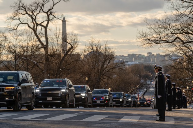 WASHINGTON, DC - JANUARY 7: Midshipmen from the U.S. Naval Academy watch as former President Jimmy Carter's funeral procession makes its way down Constitution Avenue toward the US Capitol on January 7, 2025 in Washington, DC. Carter's body will lie in state in the Capitol Rotunda until a funeral service at the National Cathedral in Washington on January 9. Carter, the 39th President of the United States, died at the age of 100 on December 29, 2024 at his home in Plains, Georgia.(Photo by Jon Cherry/Getty Images)