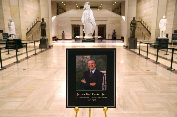 WASHINGTON, DC - JANUARY 07: A photo of former U.S. President Jimmy Carter is posted inside the U.S. Capitol on January 07, 2025 in Washington, DC. Carter's body will lie in state in the Capitol Rotunda until a funeral service at the National Cathedral in Washington on January 9. Carter, the 39th President of the United States, died at the age of 100 on December 29, 2024 at his home in Plains, Georgia. (Photo by Nathan Howard/Getty Images)