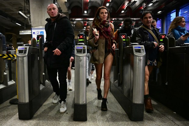 People take part in the annual "No Trousers On The Tube Day" (No Pants Subway Ride), at Waterloo station on the London Underground, in London, on January 12, 2025. This day is now marked in over 60 cities around the world. The idea behind "No Pants" is that random passengers board a subway car at separate stops in the middle of winter, without wearing trousers. (Photo by Ben STANSALL / AFP) (Photo by BEN STANSALL/AFP via Getty Images)