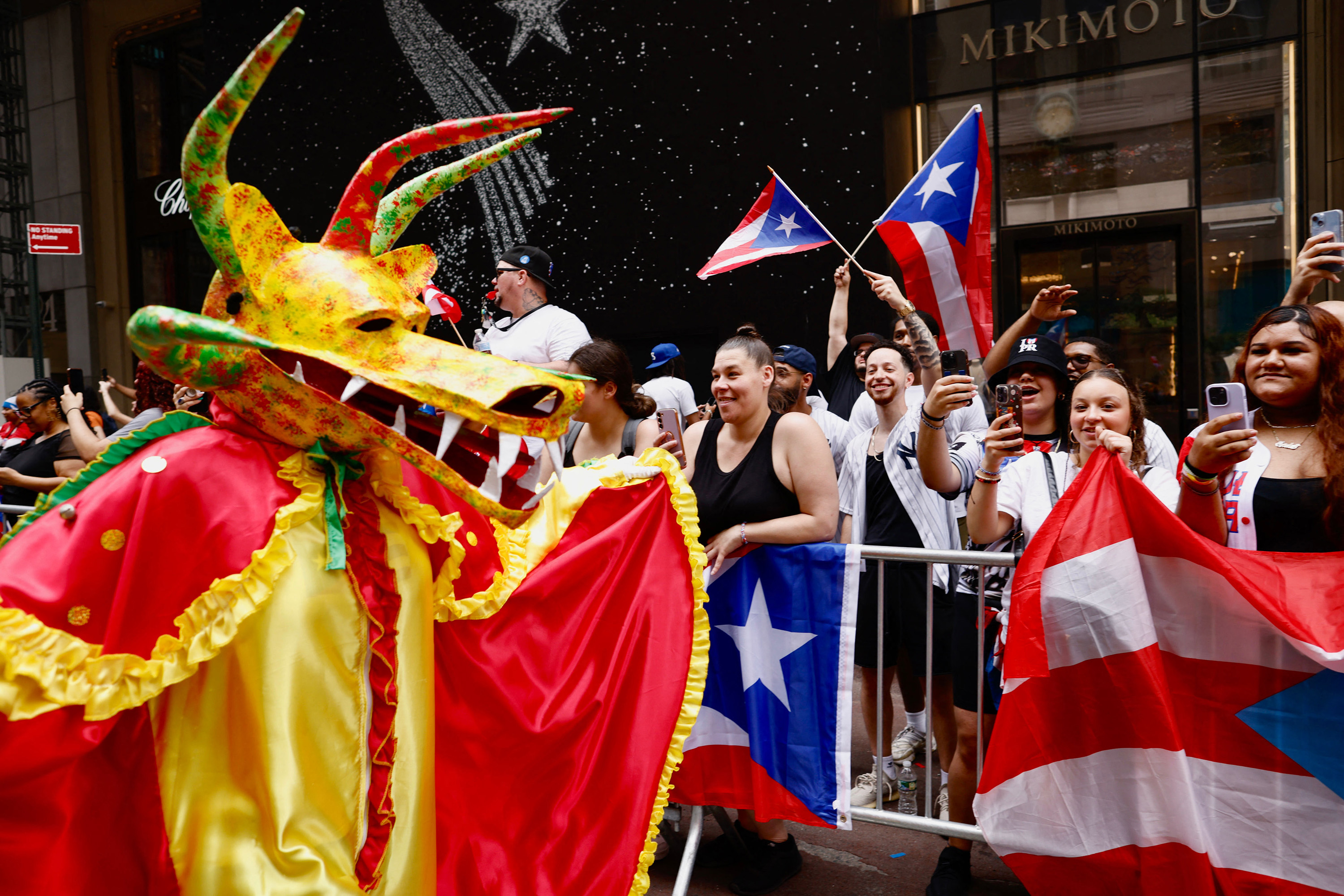 Spectators watch as participants march in the 66th annual National Puerto Rican Day Parade in New York City on June 11, 2023.