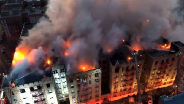 The fire broke out on the top floor of the Mayfair Apartments on Wallace Ave. near Arnow Ave. in the Allerton section of the Bronx at about 1:40 a.m. and quickly spread to the cockloft between the ceilings of the top floor apartments and the roof. (@FDNY via X.com)